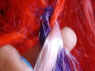 Image: Crossing the second piece of synthetic hair over the first piece