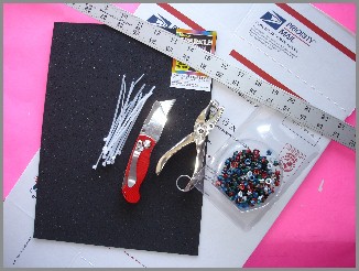 Image: Foam, zip ties, box cutter, yard stick, hole punch, and grommets