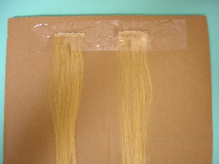 Image: Wefts taped onto a piece of cardboard