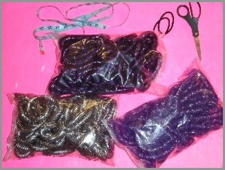 Image: Bags of cyberlox, hair ties, scissors, and measuring tape
